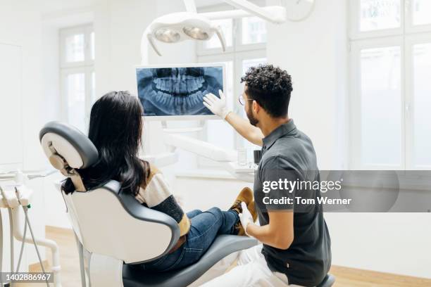 dentist showing patient x-ray of teeth after check up - inside human mouth stock pictures, royalty-free photos & images