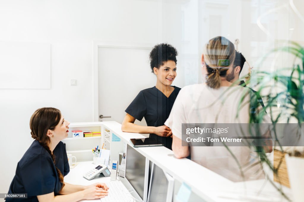Staff Talking Amongst Each Other In Dental Practice