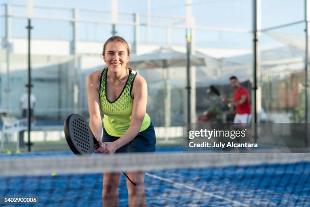 couple playing paddle tennis in court - using a paddle imagens e fotografias de stock