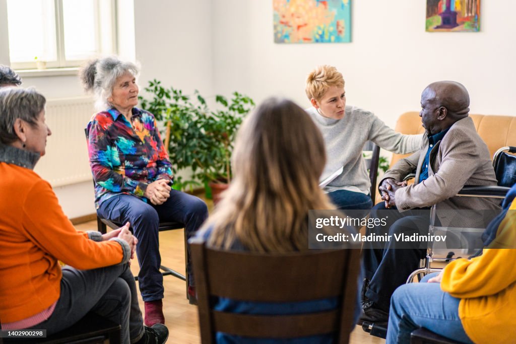 A caring clinician offers sympathy to an elderly man
