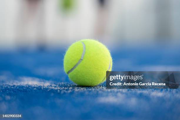 paddle tennis ball on blue turf - tennis balls stock pictures, royalty-free photos & images