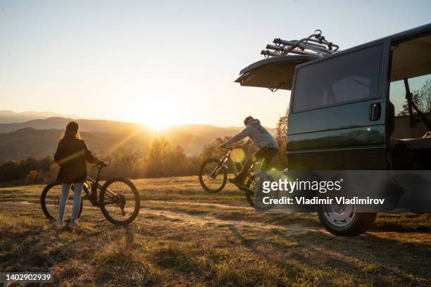 bike stunts against a setting sun - bicycle stunt stock pictures, royalty-free photos & images