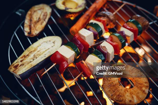 roasting vegan skewers, vegan burger patties and vegetables on bbq grill - tofu stock pictures, royalty-free photos & images