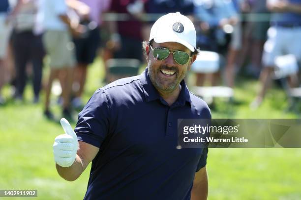 Phil Mickelson of the United States acknowledges the crowd with a thumbs up on the fifth hole during a practice round prior to the US Open at The...