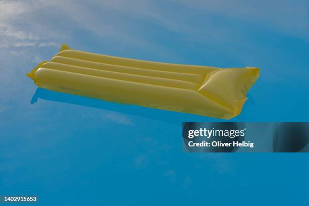 one single yellow air mattress in a empty pool - bath isolated stock pictures, royalty-free photos & images