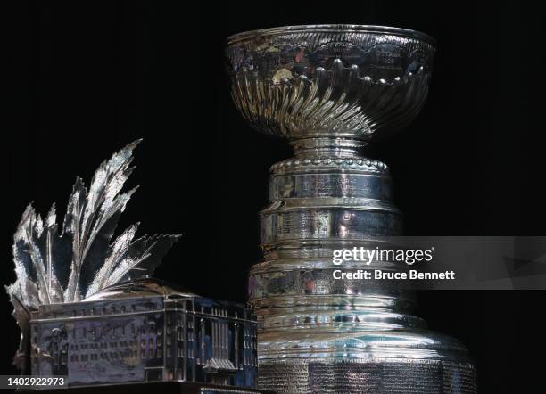 The Conn Smythe Trophy and the Stanley Cup are on display during the 2022 NHL Stanley Cup Final Media Day at Ball Arena on June 14, 2022 in Denver,...