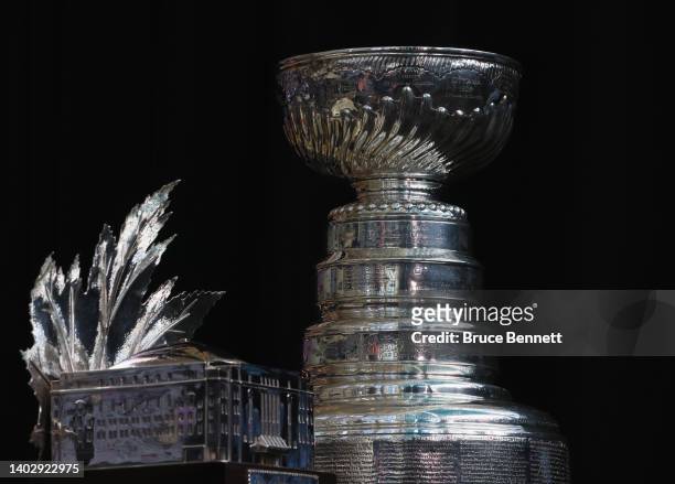 The Conn Smythe Trophy and the Stanley Cup are on display during the 2022 NHL Stanley Cup Final Media Day at Ball Arena on June 14, 2022 in Denver,...