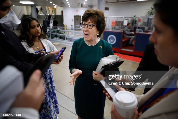 Sen. Susan Collins talks with reporters as she walks through the Senate subway following the weekly Senate Republican policy luncheon at the U.S....