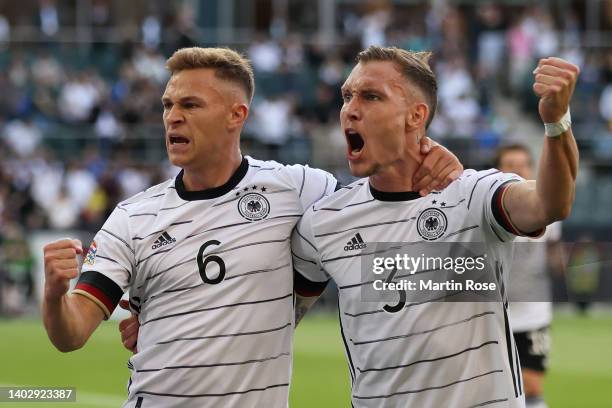 Joshua Kimmich of Germany celebrates scoring their side's first goal with teammates David Raum during the UEFA Nations League League A Group 3 match...