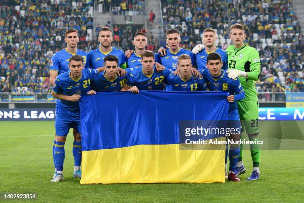 Players of Ukraine hold a flag as they pose for a photograph prior to kick off of the UEFA Nations League League B Group 1 match between Ukraine and...