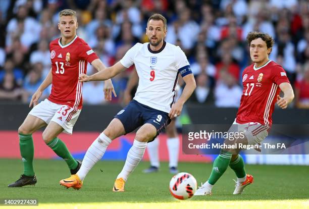 Harry Kane of England is challenged by Szabolcs Schoen and Callum Styles of Hungary during the UEFA Nations League League A Group 3 match between...