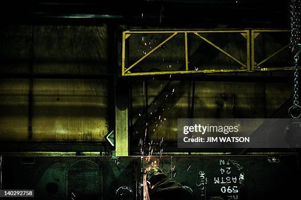 An employee at Specialty Fab in North Lima, Ohio, works on a piece of a compressor skid frame on March 1 which is bound for the Ohio Shale project....