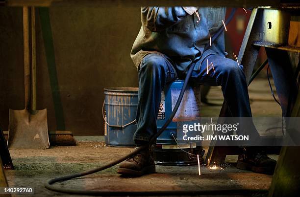 An welder at Specialty Fab in North Lima, Ohio, works on a piece of a compressor skid frame on March 1 which is bound for the Ohio Shale project....