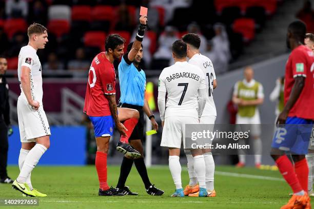 Referee Mohammed Abdulla shows Kosta Barbarouses of New Zealand a red card in the 2022 FIFA World Cup Playoff match between Costa Rica and New...