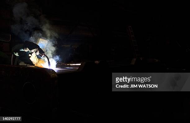 Welder at Specialty Fab, Inc., in North Lima, Ohio, works on a piece of a compressor skid frame on March 1 which is bound for the Ohio Shale project....