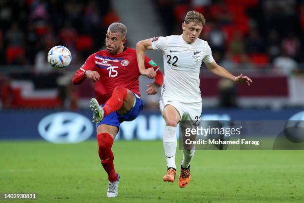 Francisco Calvo of Costa Rica is challenged by Niko Kirwan of New Zealand during the 2022 FIFA World Cup Playoff match between Costa Rica and New...