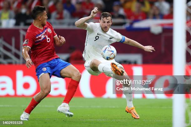 Chris Wood of New Zealand is challenged by Oscar Duarte of Costa Rica during the 2022 FIFA World Cup Playoff match between Costa Rica and New Zealand...