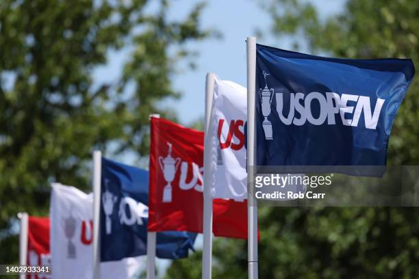 Open flags blow in the breeze on the practice range during a practice round prior to the US Open at The Country Club on June 14, 2022 in Brookline,...