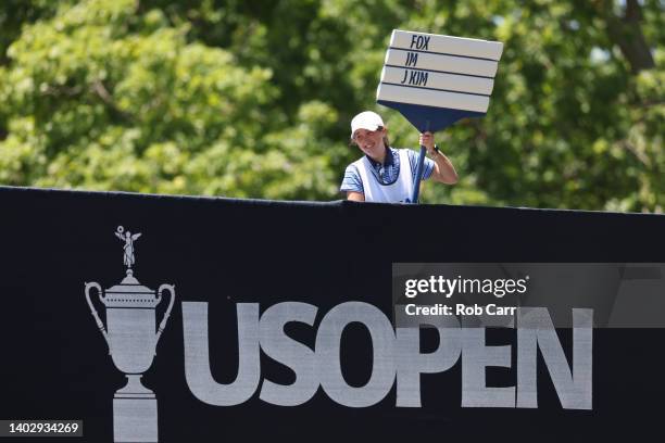 Standard bearer holds a standard with the names of Ryan Fox of New Zealand, Sungjae Im of Korea and Joohyung Kim of South Korea as seen during a...