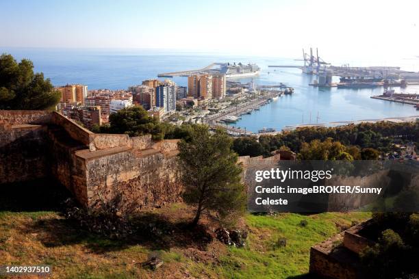 bildbanksillustrationer, clip art samt tecknat material och ikoner med malaga, view from castillo de gibralfaro to a part of the castle wall, the city and harbour, andalucia, spain - malaga