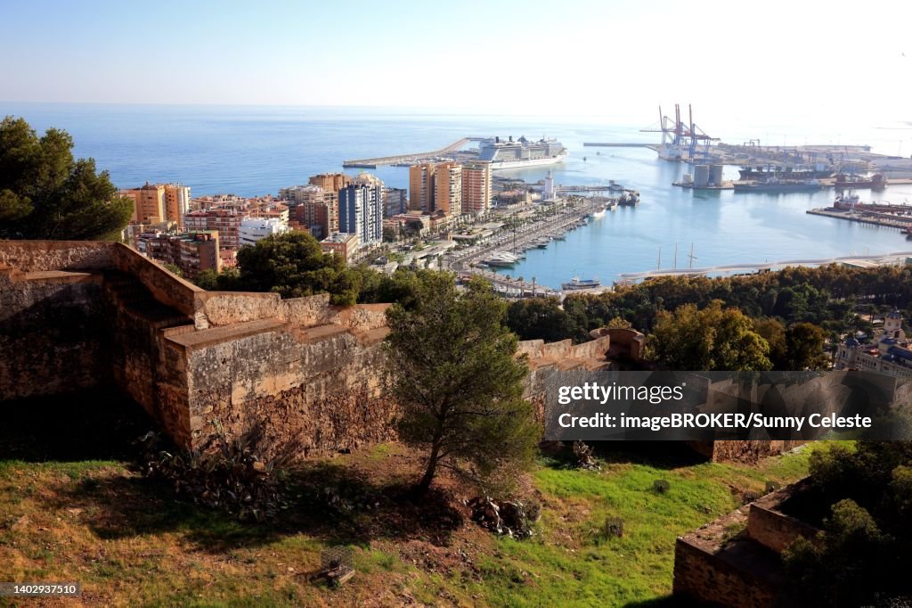 Malaga, view from Castillo de Gibralfaro to a part of the castle wall, the city and harbour, Andalucia, Spain