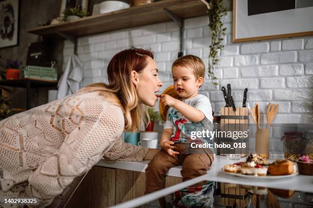 it's cakes time - licking finger stock pictures, royalty-free photos & images