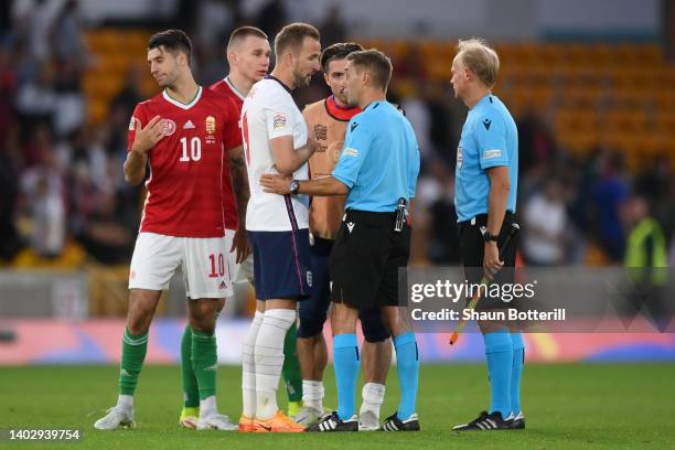 Harry Kane of England speaks to referee Clement Turpin after their sides defeat during the UEFA Nations League - League A Group 3 match between...