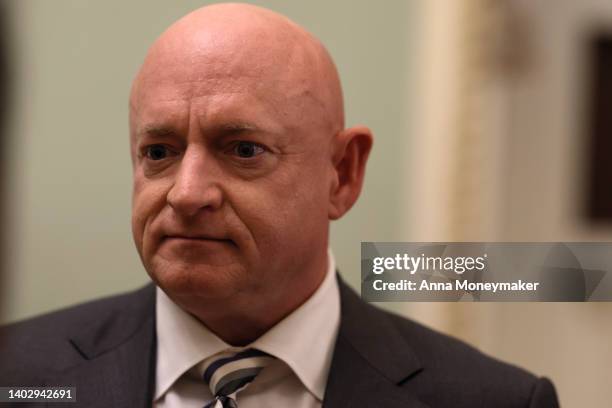 Sen. Mark Kelly speaks with a journalist before going to a luncheon with Senate Democrats on June 14, 2022 in Washington, DC. Senate negotiators are...