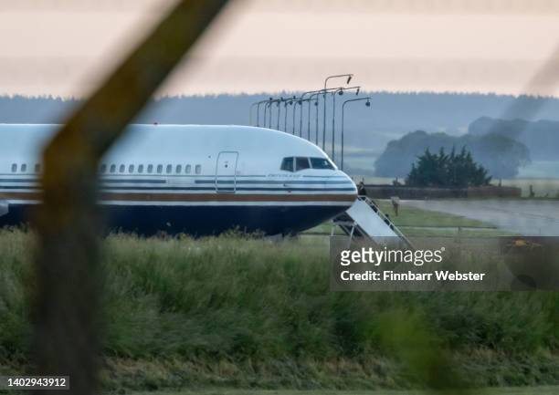 People are seen boarding the Rwanda deportation flight EC-LZO Boeing 767 at Boscombe Down Air Base, on June 14, 2022 in Boscombe Down. The Court of...