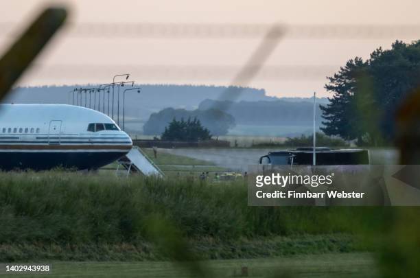 Coach pulls up to the Rwanda deportation flight EC-LZO Boeing 767 at Boscombe Down Air Base, on June 14, 2022 in Boscombe Down. The Court of Appeal...
