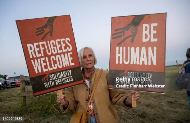 Woman protests against the Rwanda deportation flight EC-LZO Boeing 767 at Boscombe Down Air Base, on June 14, 2022 in Boscombe Down. The Court of...