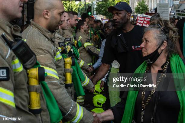 Fire Fighters are honoured and applauded as protestors take part in the 5th annual Silent Walk at Grenfell Tower on June 14, 2022 in London, England....