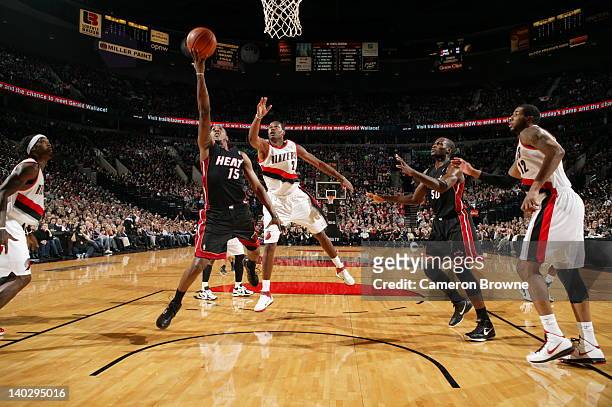 Mario Chalmers of the Miami Heat shoots a layup against Marcus Camby of the Portland Trail Blazers on March 1, 2012 at the Rose Garden Arena in...