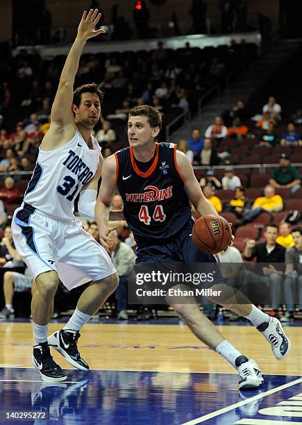 Corbin Moore of the Pepperdine Waves drives against John Sinis of the San Diego Toreros during the second round of the Zappos.com West Coast...