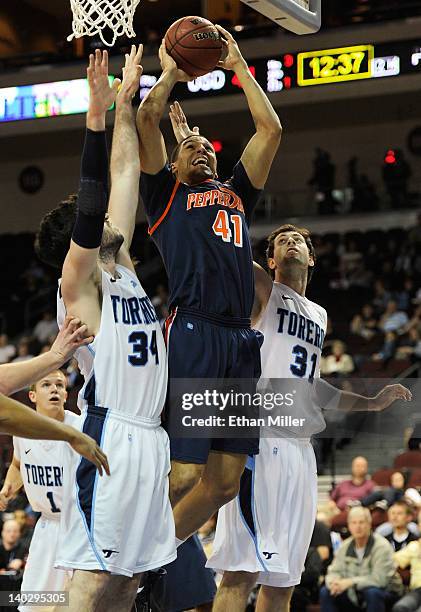 Taylor Darby of the Pepperdine Waves shoots between Chris Manresa and John Sinis of the San Diego Toreros during the second round of the Zappos.com...