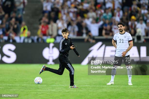 Streaker running at the pitch next to Ilkay Guendogan of Germany during the UEFA Nations League League A Group 3 match between Germany and England at...