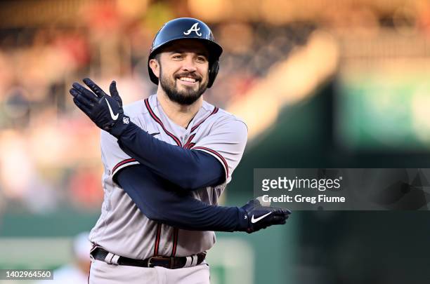 Travis d'Arnaud of the Atlanta Braves celebrates after hitting a three-run home run in the third inning against the Washington Nationals at Nationals...