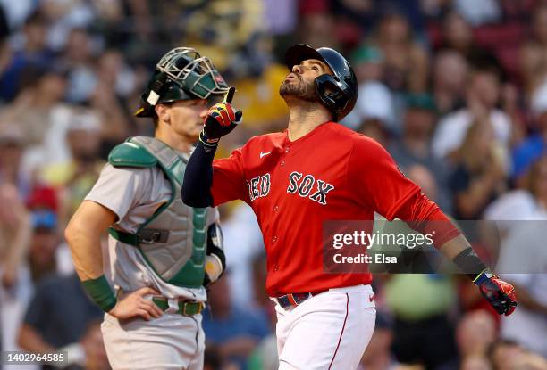 Martinez of the Boston Red Sox celebrates his solo home run as Sean Murphy of the Oakland Athletics looks on in the third inning at Fenway Park on...