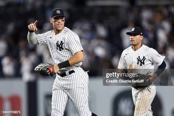Aaron Judge of the New York Yankees points to a teammate as he celebrates a 2-0 victory in the game against the Tampa Bay Rays at Yankee Stadium on...