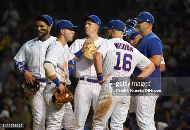 Manager David Ross of the Chicago Cubs visits the mound for a pitching change during the sixth inning against the San Diego Padres at Wrigley Field...