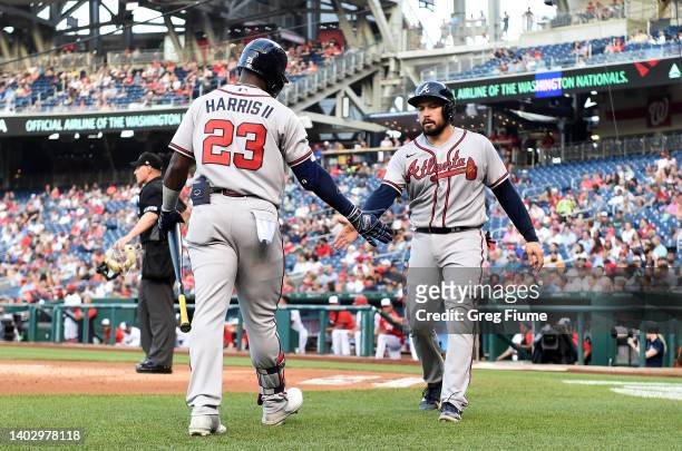 Travis d'Arnaud of the Atlanta Braves celebrates with Michael Harris II after scoring in the second inning against the Washington Nationals at...