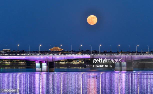 Supermoon rises over the Hanjiang River on June 14, 2022 in Xiangyang, Hubei Province of China.