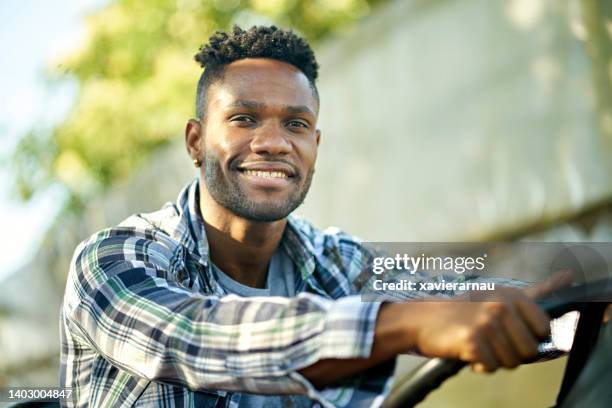 outdoor portrait of cheerful young farm worker - half shaved hairstyle bildbanksfoton och bilder