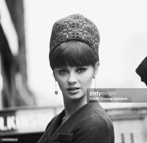 Fashion model wearing a high crown toque hat, United Kingdom, 30th October 1963.
