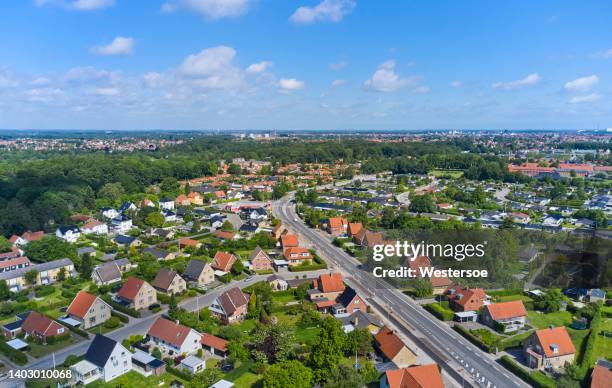 detached houses along a road - danemark stock pictures, royalty-free photos & images