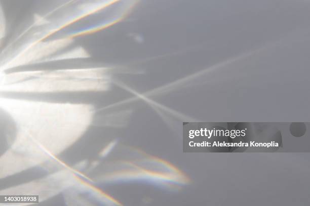 blurred dreamy surreal rainbow light refraction texture overlay effect on white wall - light and shadow stock pictures, royalty-free photos & images