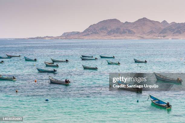 fishing boats moored at sea at village of burum - gulf of aden stock pictures, royalty-free photos & images