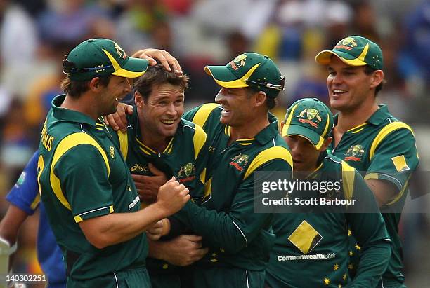 Daniel Christian of Australia is congratulated by his team mates after dismissing Sachithra Senanayake of Sri Lanka during the One Day International...