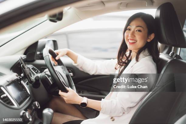 portrait of beautiful asian business woman in her car - driver's seat stock pictures, royalty-free photos & images