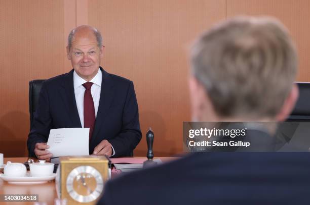 German Chancellor Olaf Scholz smiles to Finance Minister Christian Lindner at the beginning of the weekly federal government cabinet meeting on June...